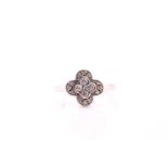 A quatrefoil diamond cluster ring, consisting of round brilliant diamonds estimated 0.15ct bezel set