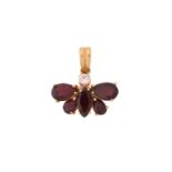 A garnet butterfly pendant, with a round colourless spinel highlight, four pear-shaped garnets and a