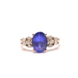 A tanzanite and diamond dress ring, featuring an oval tanzanite approximately measuring 9.8 x 7.5