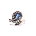 A sapphire and diamond dress ring, featuring a pear-shaped sapphire with a pale blue body colour