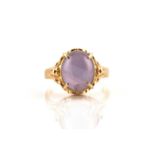 A star sapphire ring, comprises an oval star sapphire cabochon in pale purple colour,