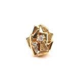 A modernist yellow metal and diamond ring, consisting of a brilliant diamond with an estimated