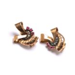 A pair of ribbon motif earrings, each set with diamond and ruby accents, backed with peg and clip