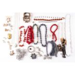 A mixed collection of costume jewellery including necklaces, bangles, clip-on earrings and various