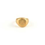 An 18ct gold signet ring, with a minuscule flower engraving on the oval head, to a tapering plain