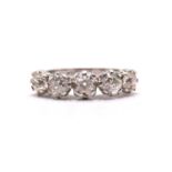 A five-stone Edwardian-style diamond dress ring, comprising one oval and four round old-mine cut