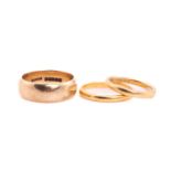 Two 22ct gold wedding bands and a 9ct gold wedding band, one comprises a plain 2.1 mm wide D-profile