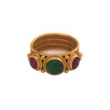 A LALAoUNIS ring with emerald and ruby, consisting of a round emerald cabochon in the centre,