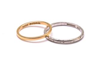 An 18ct gold ring and a platinum ring, the gold ring has a plain court band, stamped 'FIDELITY'