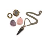 A mixed lot of pendants and brooches, to include a horn pendant on a white metal mount, to a