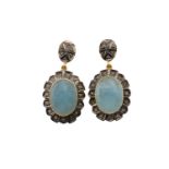 A pair of aquamarine and diamond drop earrings, each comprises an oval rose cut aquamarine collet