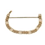 A gate link bracelet in yellow metal, with a fold-over clasp and safety chain, metal unmarked,