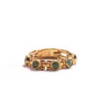 A soft chain ring with emeralds, comprises five emerald cabochons collet set on yellow metal link