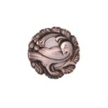 Georg Jensen - An embossed silver brooch, depicting a dove in wreath, with hinged pin stem and