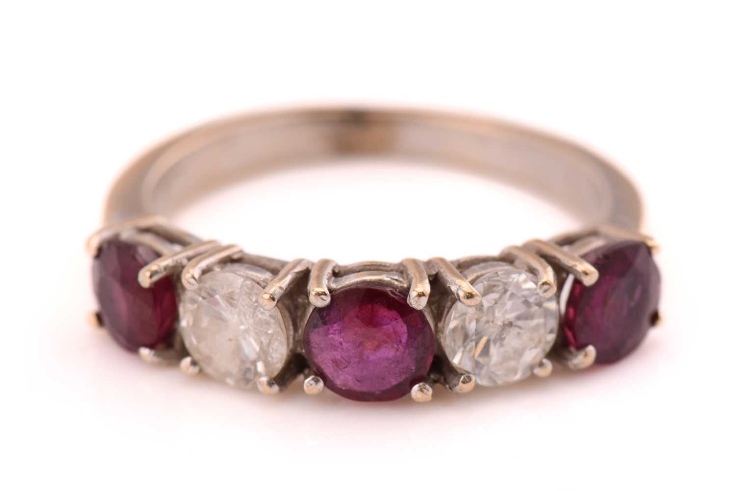 A ruby and diamond five-stones ring, consisting of two round brilliant diamonds with an estimated
