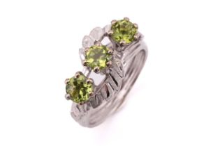 A three-stone peridot ring, comprises three round peridots each approximately measuring 4.7 mm, claw