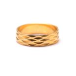 A 22ct yellow gold wedding ring, with geometric pattern carved throughout the band, engraved '