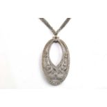 A Belle Époque style diamond pendant on chain, featuring an oval pendant with foliate and ribbon