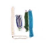 Five necklaces comprising a multi-strand blue glass bead necklace, a similar green example, a