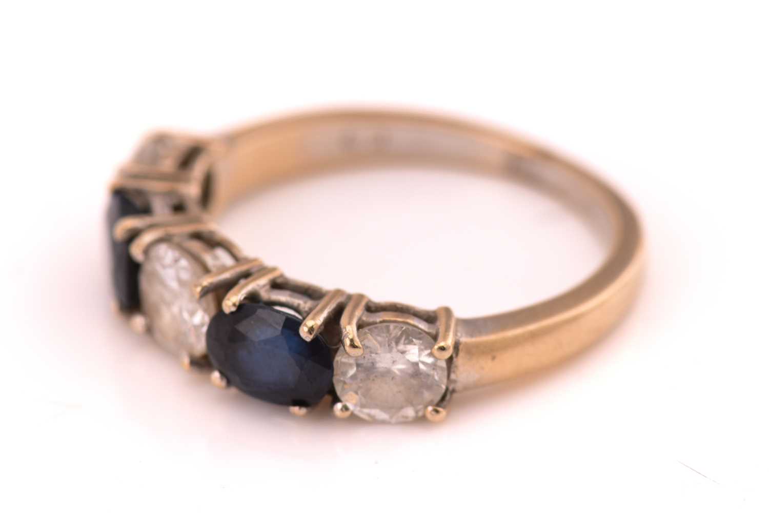 A sapphire and diamond ring, consisting of two oval sapphires alternating with three round brilliant - Image 2 of 4