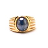 A sapphire gypsy ring, featuring a high dome sapphire cabochon with dark blue body colour,