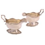 A pair of George II style silver sauce boats, Sheffield 1905 by Thomas Bradbury & Sons, with