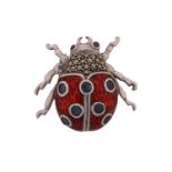 A contemporary white metal and cold enamel insect brooch/ pendant in the form of a "Lady Bird"