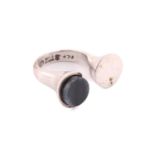 Georg Jensen - A dress ring with polished hawk's eye, comprises an open shank with a flat round