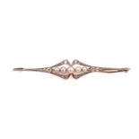 A diamond and seed pearl bar brooch, featuring five graduated seed pearls with pink overtones,