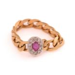 A soft chain ring with ruby and diamonds, ring head comprises an oval ruby encircled with diamond