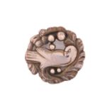 Georg Jensen - An embossed silver brooch, depicting dove in wreath with silver dome accents, with