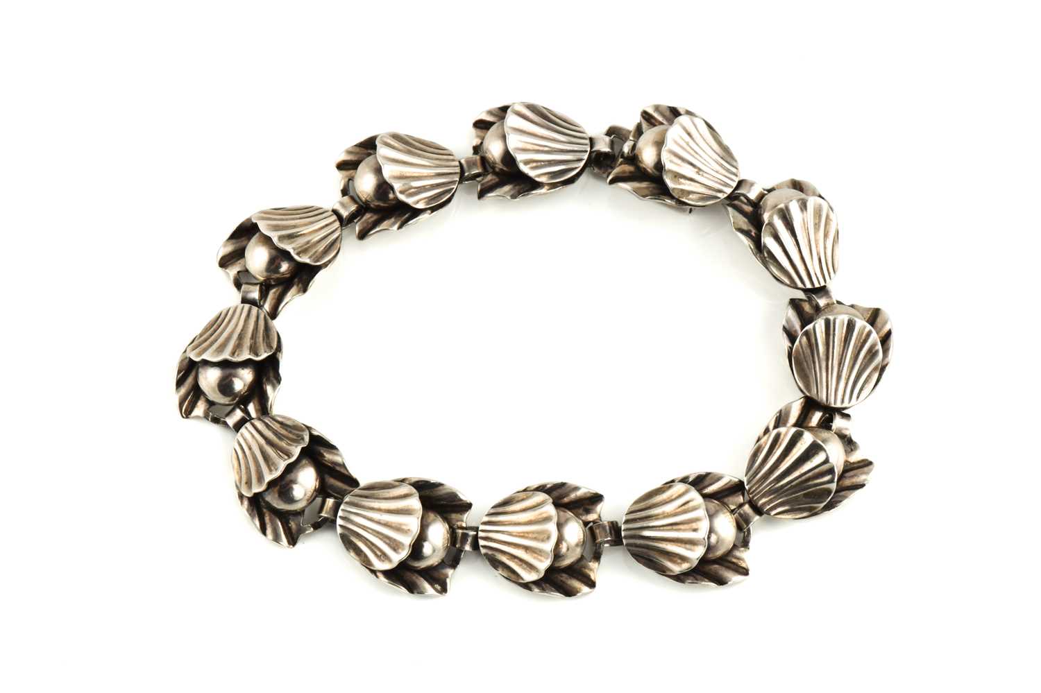 A bracelet by Danish designer Hermann Siersbol, with stylised shell and pearl links in white