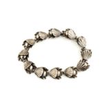 A bracelet by Danish designer Hermann Siersbol, with stylised shell and pearl links in white