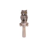 A 20th century Sterling silver and mother of pearl "Owl" form baby's teething rattle with inset