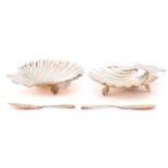 A Victorian presentation cased pair of scallop shell form silver butter dishes with corresponding