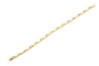 A 9ct gold and diamond line bracelet, featuring hinged bar links flanked by square links with