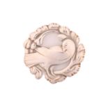 Georg Jensen - An embossed silver brooch, depicting dove in wreath, with hinged pin stem and