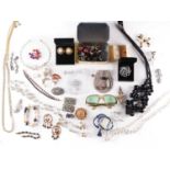 A mixed collection of costume jewellery, comprising of beaded necklaces, brooches, clip-on earrings,