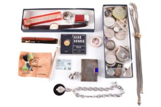 A box filled with coins, pens, watches, jewellery and a powder case.An untested gold 25 Riyals