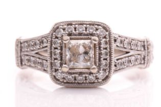 A Vera Wang Love ring with diamonds on 14kt white gold, set with a central princess cut diamond