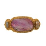 An Indian gem-set brooch, featuring a foil-backed quartz in the centre with a polished surface,