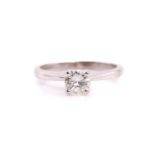 A single stone diamond ring, the round brilliant cut diamond in simple raised claw mount; to