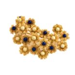 An enamelled abstract brooch, comprises an organically formed cast mount in yellow precious metal,