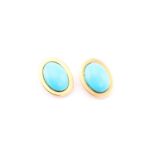 A pair of turquoise ear clips, each consisting of an oval turquoise cabochon approximately measuring