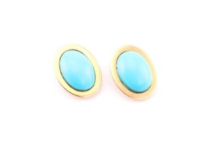 A pair of turquoise ear clips, each consisting of an oval turquoise cabochon approximately measuring
