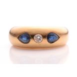 A sapphire and diamond gypsy ring, consisting of a brilliant diamond flush set in the middle flanked