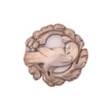 Georg Jensen - An embossed silver brooch, depicting a dove in wreath, with hinged pin stem and