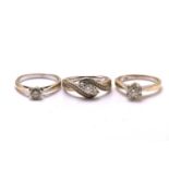 Three diamond rings in yellow gold, one consisting of a round brilliant diamond with an estimated