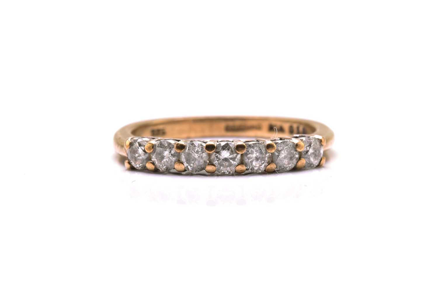 A 9ct gold seven-stone diamond ring, consisting of seven brilliant diamonds with an estimated