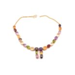 A multi gem-set rivière necklace in gilt metal, comprises a variety of oval mixed-cut gemstones such
